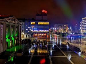 una strada di città di notte con un arcobaleno di Rynek 7 a Katowice