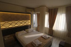 a bedroom with a bed with a light above it at Grand Liza Hotel in Istanbul