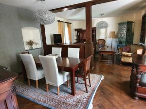 a living room with a dining room table and chairs at Haus Irblingweg in Stiefern