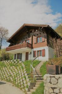 a house with stairs in front of it at Stachelbeere UG in Fiesch