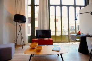 a living room with a coffee table and a large window at L&acute;Aguila Suites - Turismo de Interior in Palma de Mallorca