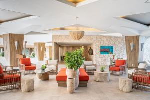 a lobby with couches and tables and chairs at Dreams Curacao Resort, Spa & Casino in Willemstad