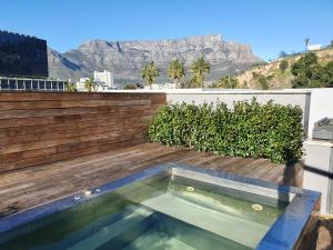 a swimming pool on the roof of a house at De Waterkant Cottages in Cape Town