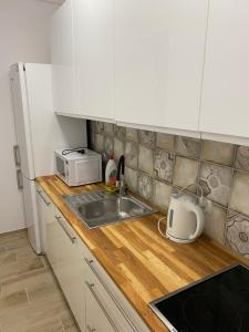 a kitchen counter with a sink and a microwave at Pokoje na wynajem Sopot in Sopot