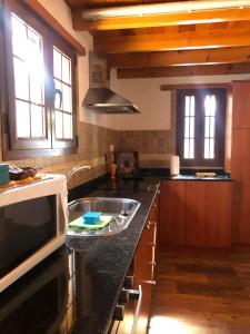 a kitchen with a sink and a counter top at Casa Naranjo in Ayacata