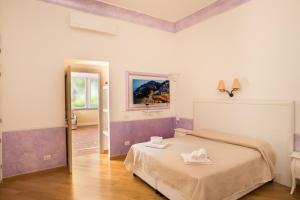 a bedroom with a bed with two white towels on it at De Vivo Realty - Ilary House Positano in Positano