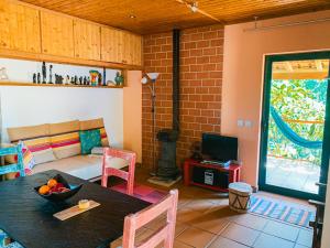 a living room with a table and a couch at Ecobosque in Nadadouro