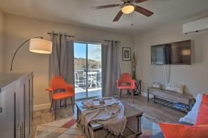 a living room with a ceiling fan and orange chairs at Pet-Friendly Belton Lake Studio with Deck and Kayaks! in Belton