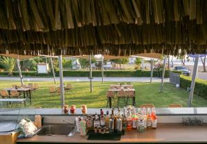 a kitchen counter with a sink and an umbrella at Apolonio Pefki Evia in Pefki