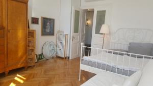 een witte slaapkamer met een bed en een kast bij Room next to Porto Montenegro in Tivat