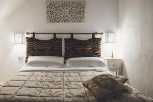 a bedroom with a large bed with a large bedspread at HolidayMonopoli in Monopoli