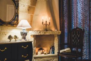 a room with a fireplace with a lamp and a chair at HolidayMonopoli in Monopoli