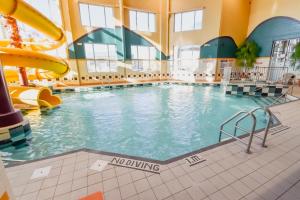 a large indoor swimming pool with a water slide at Canad Inns Destination Centre Polo Park in Winnipeg