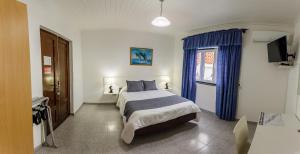 Кровать или кровати в номере Hospedaria Australia