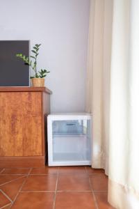 a white microwave oven sitting on a floor in a room at Surfescape Fuerteventura in Lajares
