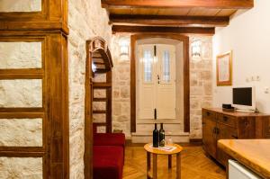 a living room with a ladder and a room with a table at Apartment Soul of the Town in Dubrovnik