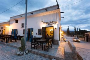 a restaurant on the side of a street at night at Viracocha Art Hostel Cachi in Cachí