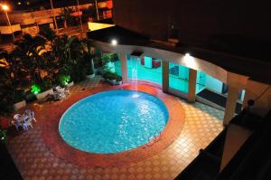 a swimming pool with a pool table and chairs at Biss Inn Hotel in Goiânia