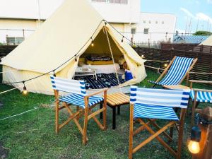 a tent with two chairs and a table in the grass at GRAN BLUE - Vacation STAY 11224v in Minamiboso