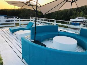 a deck with blue chairs and tables and an umbrella at GRAN BLUE - Vacation STAY 11224v in Minamiboso