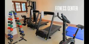 a gym with three treadmills and a fitness center at Condomínio Vista Azul in Pedra Azul