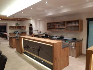 a kitchen with a counter with a picture of a mountain at Gasthof Venedigerblick in Neukirchen am Großvenediger