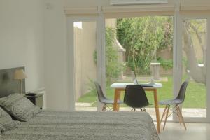 a bedroom with a bed and a table with a laptop on it at Descanso en Tandil in Tandil