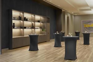 a lobby with a row of black stools at Kimpton Sawyer Hotel by IHG in Sacramento