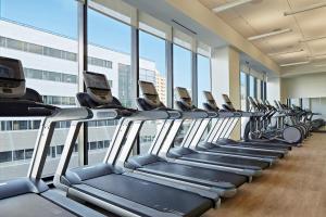 a row of treadmills in a gym with windows at Kimpton Sawyer Hotel, an IHG Hotel in Sacramento
