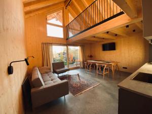 a living room with a couch and a table at Ferienhaus Königsdorf - Urlaub im Tölzer Land in Königsdorf