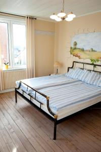 a bedroom with a large bed with a painting on the wall at Reftele Wardshus in Reftele