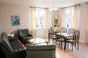 a living room with a table and chairs at Reftele Wardshus in Reftele