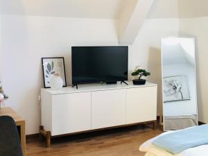 a white cabinet with a television on top of it at B&S Apartments in Zlatibor