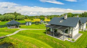 an aerial view of a house with a playground at Hygge Domki in Junoszyno