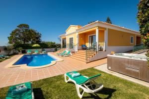 a villa with a swimming pool and a house at Villa Alegria in Albufeira