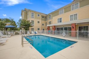 a swimming pool in front of a building at MainStay Suites Port Saint Joe in Port Saint Joe