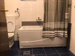 a bathroom with a tub and a toilet and a shower at Apartman Samardžić in Višegrad +20 photos