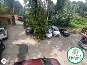 a group of cars parked in a parking lot at Pousada Naturale in Trindade