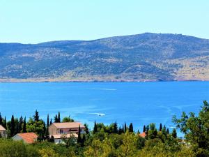 a large body of water with a house and trees at STONE VILLA-MILAN Pool Sea View Lounge Room in Starigrad-Paklenica +36 photos