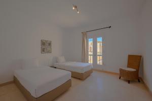 A bed or beds in a room at VESTA - El Gouna Residence