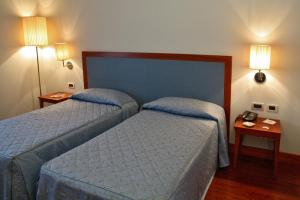Postel nebo postele na pokoji v ubytování Hotel Del Campo