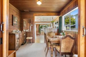 a dining room and kitchen in a tiny house at The Lake Bach - Ngongotaha Lakefront Holiday Home in Ngongotaha