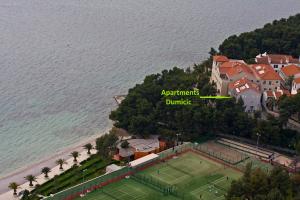 an aerial view of a tennis court next to the ocean at Apartments Lavica Beach Dumičić in Podstrana