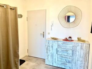 a bathroom with a blue dresser and a mirror at Cottbus-Apartments - Red Apartment I privat I Wifi I Küche I Balkon in Cottbus +17 photos