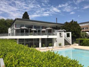 a large house with a swimming pool in front of it at Apartamento en Country Pilar Piscina Parrilla propia hasta 4 personas in Pilar +27 photos