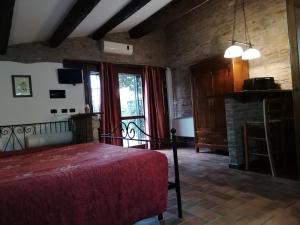 a bedroom with a bed and a tv at Casale Belriguardo in Ferrara