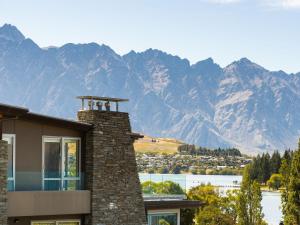 a house with a view of the mountains at Maison de Charme Central Apartment in Queenstown