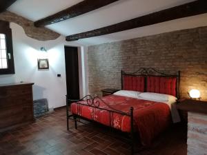 a bedroom with a bed and a fireplace at Casale Belriguardo in Ferrara