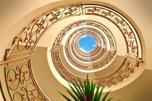 a spiral staircase with a blue sky in the middle at KAKTUS Hotel Kaktus Albir in Albir