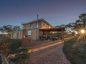 a brick house with a patio in front of it at Alpine Drovers Rest 20 Iron Pot Creek in Jindabyne
